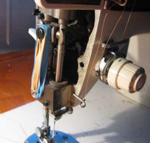 old Singer Merritt sewing machine with rubber bands on it