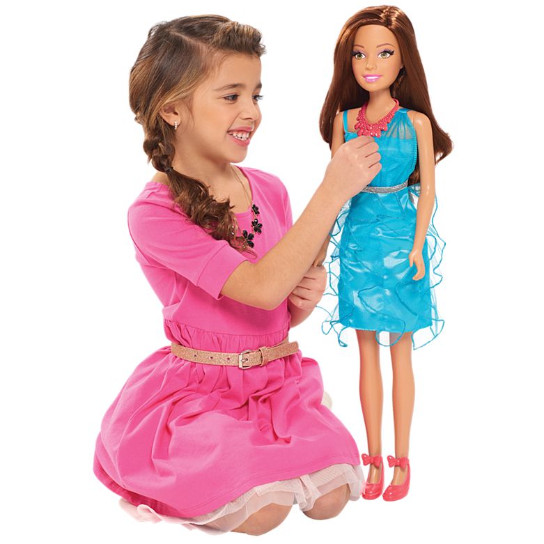 Mattel image of little girl kneeling next to 28 inch Barbie